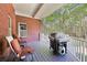 Outdoor deck featuring wood flooring, outdoor seating, a grill, and a lush, green surrounding landscape at 270 Morrow Rd, Newborn, GA 30056