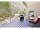View of the outdoor deck featuring wood flooring, a grill, outdoor chairs, and a lush, green surrounding landscape at 270 Morrow Rd, Newborn, GA 30056