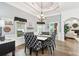 Dining area with wood floors and black and white decor, complemented by natural light and an inviting atmosphere at 270 Morrow Rd, Newborn, GA 30056