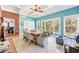 Bright dining area featuring tile flooring, a brick wall, and a spacious seating arrangement with views of the outdoors at 270 Morrow Rd, Newborn, GA 30056