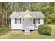 Charming cottage with white siding, black shutters, covered porch, and a well-maintained front yard at 270 Morrow Rd, Newborn, GA 30056