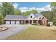 Sprawling brick home with a four car garage, circular drive, mature trees and pristine landscaping at 270 Morrow Rd, Newborn, GA 30056