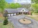 A brick house with a three-car garage, circular driveway, and well-manicured lawn on a sunny day at 270 Morrow Rd, Newborn, GA 30056