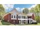 A red brick house boasting an elevated sunroom and a walkout basement is surrounded by a lush green lawn at 270 Morrow Rd, Newborn, GA 30056