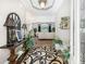 Inviting foyer with hardwood floors, console table, decorative mirror, and plants leading to the living room at 270 Morrow Rd, Newborn, GA 30056