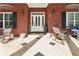 Inviting front porch with rocking chairs and tile flooring at 270 Morrow Rd, Newborn, GA 30056