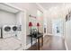 Hallway leading to a well-lit laundry room with a front loading washer and dryer at 270 Morrow Rd, Newborn, GA 30056