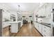 Well-appointed kitchen with an island, modern appliances, and white cabinetry flowing into the dining area at 270 Morrow Rd, Newborn, GA 30056