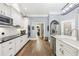 Modern kitchen featuring white cabinets, stainless steel appliances, granite countertops, and hardwood flooring at 270 Morrow Rd, Newborn, GA 30056