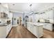 Bright kitchen with a large island, stainless steel appliances, white cabinets, and hardwood floors throughout at 270 Morrow Rd, Newborn, GA 30056