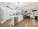 Modern kitchen with stainless steel appliances, white cabinetry, a marble island, and a view into the dining area at 270 Morrow Rd, Newborn, GA 30056