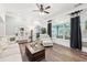 Sunlit living room featuring hardwood floors, a large window with custom drapes, and comfortable seating at 270 Morrow Rd, Newborn, GA 30056