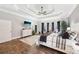 Luxurious primary bedroom with a tray ceiling, hardwood floors, and ample natural light for a serene retreat at 270 Morrow Rd, Newborn, GA 30056