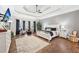 Spacious primary bedroom features hardwood floors, a tray ceiling, and a cozy sitting area at 270 Morrow Rd, Newborn, GA 30056