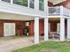 Covered patio area with brick walls, white columns, double doors, and potential for outdoor activities at 270 Morrow Rd, Newborn, GA 30056
