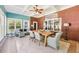 Bright sun room with brick walls, coffered ceiling, tile floors, dining table, and many windows at 270 Morrow Rd, Newborn, GA 30056