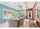 Cozy sunroom with bright windows, exposed brick, and a dining table for enjoying serene views at 270 Morrow Rd, Newborn, GA 30056