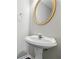 Elegant half bathroom with a pedestal sink and decorative mirror at 3380 Duncan Bridge Dr, Buford, GA 30519