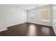 Bright bedroom with dark hardwood floors and two windows providing natural light at 3380 Duncan Bridge Dr, Buford, GA 30519