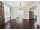 Bright dining room featuring dark wood floors, crown molding, and seamless access to other rooms at 3380 Duncan Bridge Dr, Buford, GA 30519
