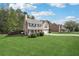 Spacious lawn showcasing house with neutral siding, well-kept garden, and a long driveway at 3380 Duncan Bridge Dr, Buford, GA 30519