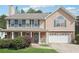 Charming two-story home featuring stone accents, a covered porch, and a well-manicured front lawn at 3380 Duncan Bridge Dr, Buford, GA 30519
