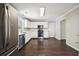 Modern kitchen featuring white cabinets, stainless steel appliances, and dark wood floors at 3380 Duncan Bridge Dr, Buford, GA 30519