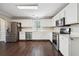 Modern kitchen featuring white cabinets, stainless steel appliances, and a well-lit countertop at 3380 Duncan Bridge Dr, Buford, GA 30519