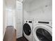 Convenient laundry room with modern washer and dryer units and shelving at 3380 Duncan Bridge Dr, Buford, GA 30519
