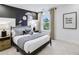 Stylish bedroom with space-themed art, dark wood accents, and plenty of natural light at 5210 Birch Valley Rd, Cumming, GA 30028