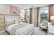 Charming bedroom featuring floral wallpaper, comfortable chair, and bright windows at 5210 Birch Valley Rd, Cumming, GA 30028