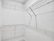 Empty walk-in closet with metal racks at 5210 Birch Valley Rd, Cumming, GA 30028