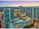 Aerial of the building featuring a rooftop pool, parking garage and views of the city and surrounding area at 250 Pharr Ne Rd # 405, Atlanta, GA 30305