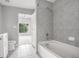 Tiled bathroom with tub, shower, and access to main bedroom at 250 Pharr Ne Rd # 405, Atlanta, GA 30305
