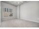 This bedroom has a large window with blinds, carpeted floors and light gray walls and an overhead fan at 250 Pharr Ne Rd # 405, Atlanta, GA 30305