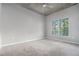 Bright bedroom with soft carpeting and a large window at 250 Pharr Ne Rd # 405, Atlanta, GA 30305