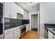 Galley kitchen with stainless steel appliances and black backsplash at 250 Pharr Ne Rd # 405, Atlanta, GA 30305