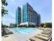 The pool area features lounge chairs and umbrellas with the surrounding building view behind the grounds at 250 Pharr Ne Rd # 405, Atlanta, GA 30305