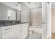 Bathroom with granite countertop, white cabinets and tiled tub/shower combination at 250 Pharr Ne Rd, Atlanta, GA 30305