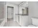 Bathroom featuring granite counters, tile floors, and ample cabinet storage space at 250 Pharr Ne Rd, Atlanta, GA 30305