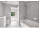 Bathroom with a tub and shower combo, tile surround and storage cabinet at 250 Pharr Ne Rd, Atlanta, GA 30305