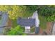 Beautiful aerial view of a well-maintained home with a dark roof and freshly landscaped yard surrounded by lush trees at 307 Gordon Woods Sw Dr, Mableton, GA 30126