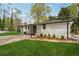 Well-maintained backyard featuring a freshly painted house, green lawn, and manicured landscaping at 307 Gordon Woods Sw Dr, Mableton, GA 30126