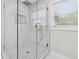 Modern bathroom featuring a glass shower with stylish tile and a rainfall shower head at 307 Gordon Woods Sw Dr, Mableton, GA 30126
