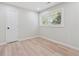 A serene bedroom with natural light from a large window and fresh floors at 307 Gordon Woods Sw Dr, Mableton, GA 30126
