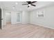 Spacious bedroom features wood flooring, ceiling fan, ample windows, and adjacent bathroom and closet at 307 Gordon Woods Sw Dr, Mableton, GA 30126
