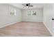 Bright bedroom with modern ceiling fan, light wood floors and two bright windows at 307 Gordon Woods Sw Dr, Mableton, GA 30126