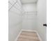 A clean walk-in closet with wire shelving, and sleek wooden floors provides storage solutions at 307 Gordon Woods Sw Dr, Mableton, GA 30126