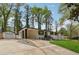 A spacious driveway leads to a charming white brick home, complete with a detached garage at 307 Gordon Woods Sw Dr, Mableton, GA 30126
