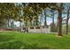 Ranch home with lush green lawn and mature shade trees at 307 Gordon Woods Sw Dr, Mableton, GA 30126
